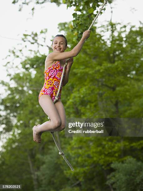 portrait of a girl swinging on a rope - oscillare stock pictures, royalty-free photos & images