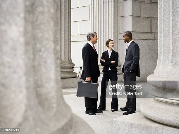 three lawyers talking in front of a courthouse - politician meeting stock pictures, royalty-free photos & images