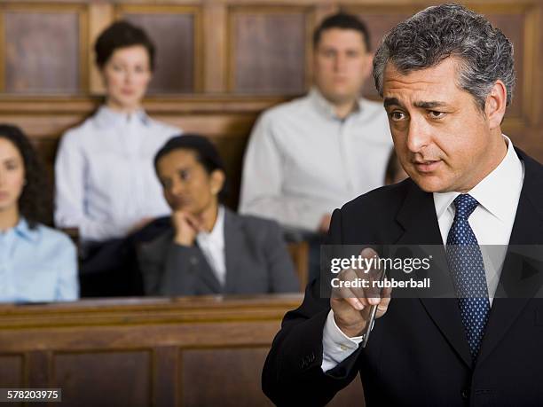 a male lawyer talking in a courtroom - lawyers arguing stock pictures, royalty-free photos & images