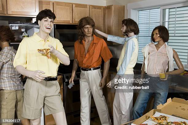 five mannequins portraying a family in the kitchen - futurista stock pictures, royalty-free photos & images