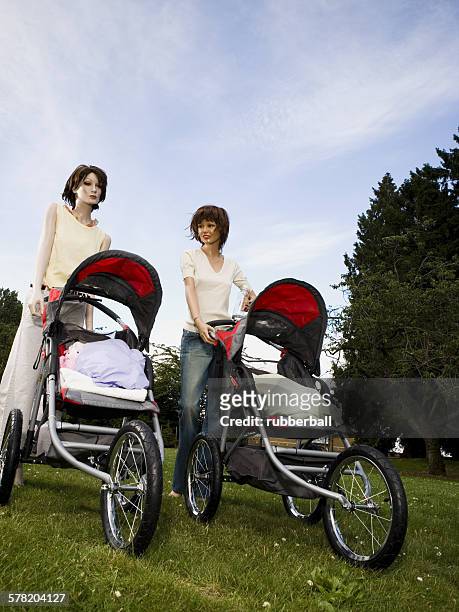 low angle view of two mannequins portraying mothers pushing prams - futurista stock pictures, royalty-free photos & images