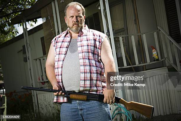 overweight man with a shotgun - redneck stock pictures, royalty-free photos & images