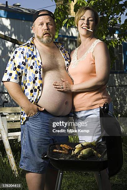 overweight couple in a trailer park - female beer belly stock pictures, royalty-free photos & images