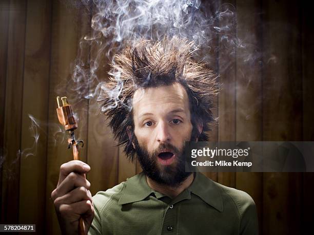 man after electric shock with electric plug and smoke - choque elétrico - fotografias e filmes do acervo