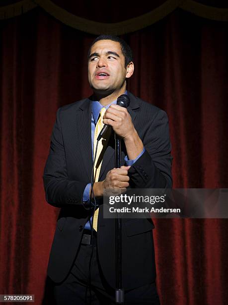 man in suit with microphone making funny faces - comedian mic stock pictures, royalty-free photos & images