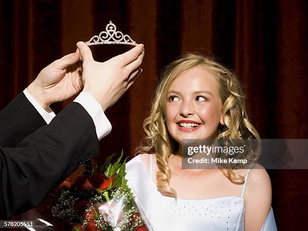 beauty pageant winner smiling and holding roses - child beauty pageant stock pictures, royalty-free photos & images