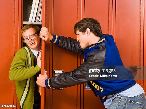 high school jock and a nerd. - hazing stock pictures, royalty-free photos & images