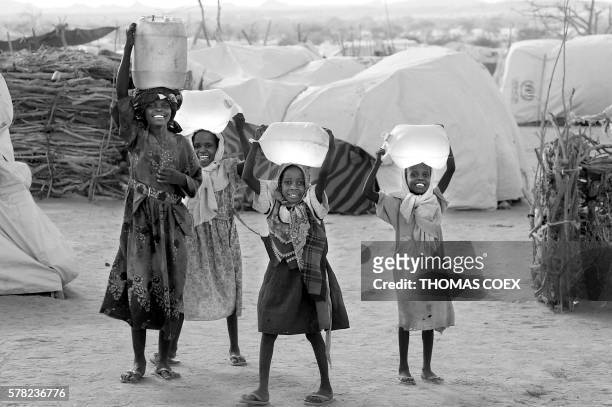 Sudan's refugees carry water at the Iridimi refugee camp where 15.000 refugees have fled the Darfur region where rebels attacked the population 26...