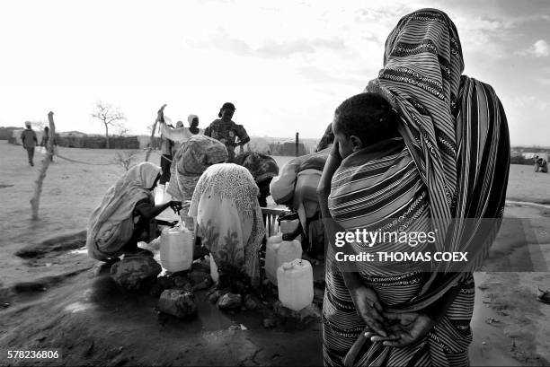 Sudan's refugees collect water at the Iridimi refugee camp where 15.000 refugees have fled the Darfur region where rebels attacked the population 26...