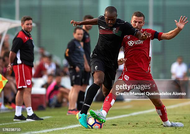 Dimitri Foulquier of Granada is tackled by Gary O'Neil of Bristol City during the friendly match between Granada CF and Bristol City at Pinatar Arena...