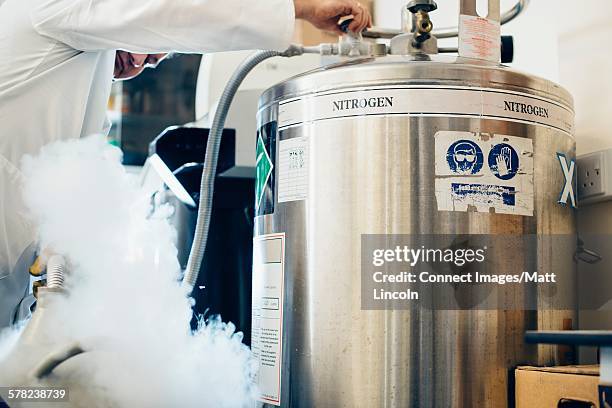 science students experimenting with liquid nitrogen in laboratory - nitrogen stock pictures, royalty-free photos & images