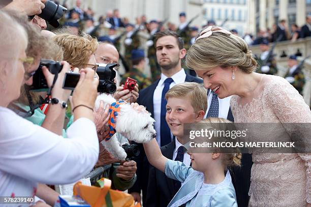 Queen Mathilde of Belgium, Princess Eleonore and Prince Emmanuel look at a dog after attending the Te Deum mass, on the occasion of today's Belgian...