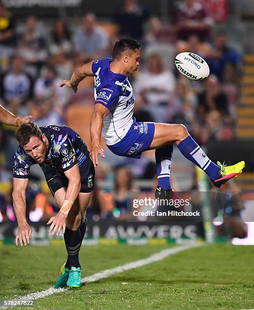 Gavin Cooper of the Cowboys contests a high ball with Sam Perrett of the Bulldogs during the round 20 NRL match between the North Queensland Cowboys...
