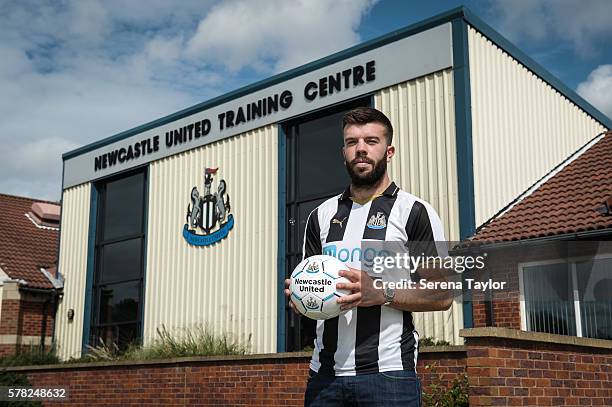 Grant Hanley poses for a photograph wearing a home shirt and holding a football at the Newcastle United Training Centre on July 21 in Newcastle upon...