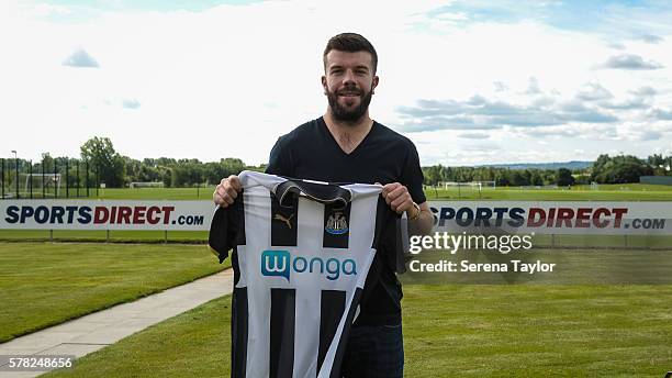 Grant Hanley poses for photographs holding a home shirt at the Newcastle United Training Centre on July 21 in Newcastle upon Tyne, England.
