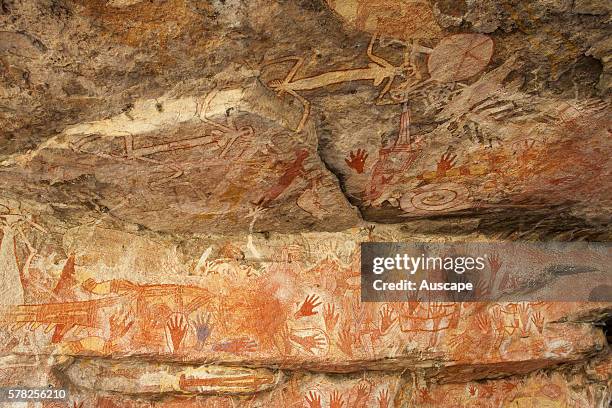 Stenciled hands and paintings in the Main Art Site. Rock art at Mount Borradaile dates back many thousands of years. Mount Borradaile, Awunbarna,...