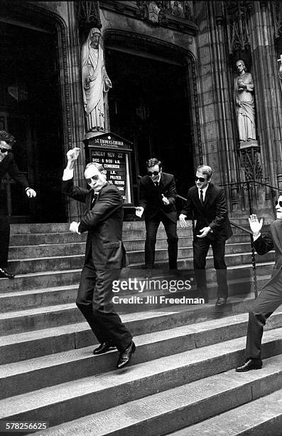 As his friends clap, an unidentified man snaps his fingers as he dances on the steps of Saint Thomas Church , New York, New York, November 1971. All...