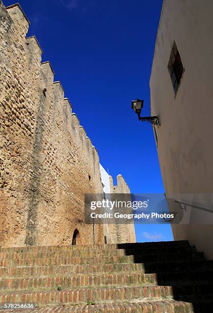 Historic street and castle walls in the village of Vejer de la Frontera, Cadiz Province, Spain.