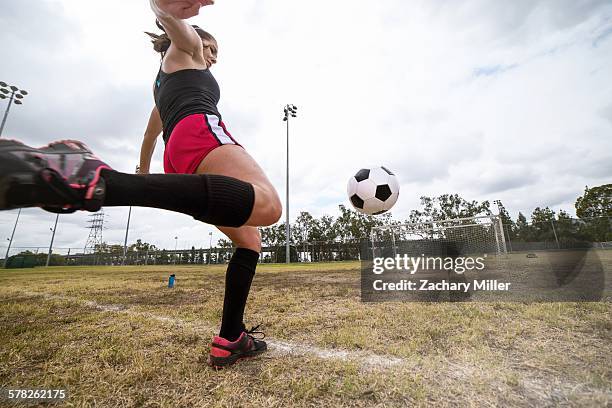 soccer player practising in field - knee length fotografías e imágenes de stock