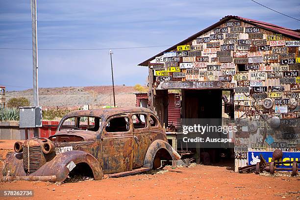 An old garage wall decorated with number plates, in a ghost town, Gwalia was a gold-mining town, Underground mining began in 1897 at the Sons of...