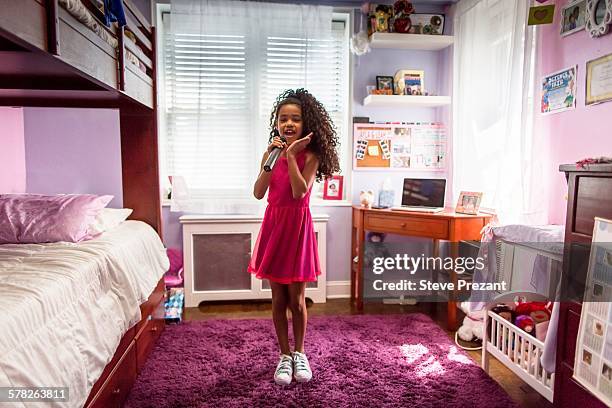 girl in bedroom singing into microphone and dancing - girl singing imagens e fotografias de stock