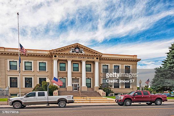 elko nevada county court house with trucks and flags - elko nevada stock pictures, royalty-free photos & images