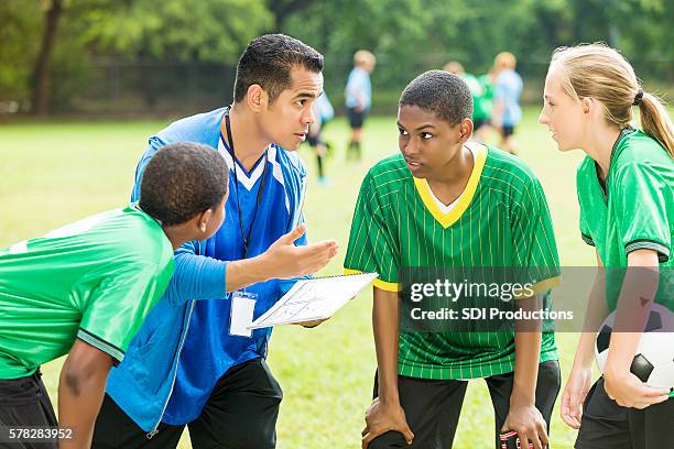 soccer coach talks about play during time out - teenager playing football stock pictures, royalty-free photos & images