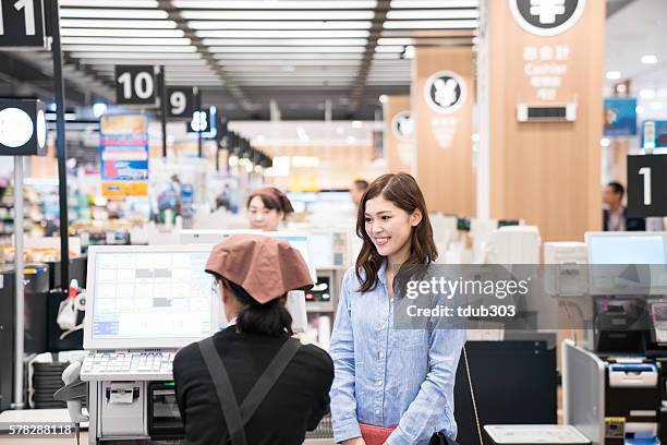 woman at supermarket check out cash register ready to pay - checkout register stock pictures, royalty-free photos & images