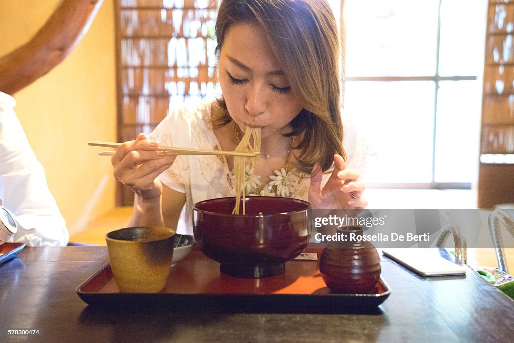 Cheerful businesswomen meeting over lunch in a Japanese restaurant