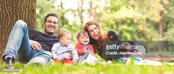 happy family outdoors in nature laughing - family panoramic stock pictures, royalty-free photos & images