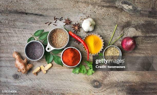 flat lay overhead view herb and spices on rustic wooden background. - curry leaves stockfoto's en -beelden