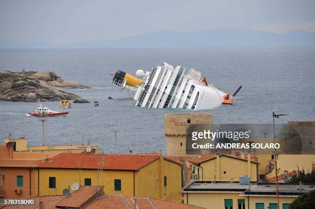 View of the wrecked cruise liner Costa Concordia on January 16 in the harbour of the Tuscan island of Giglio after it ran aground after hitting...