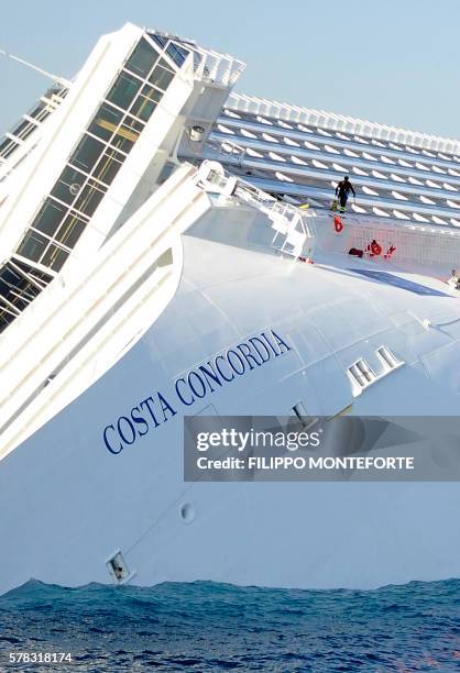 View of the Costa Concordia on January 14 after the cruise ship ran aground and keeled over off the Isola del Giglio, last night. Three people died...