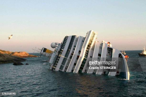 Photograph taken early on January 14, 2012 of the Costa Concordia after the cruise ship with more than 4,000 people on board ran aground and keeled...