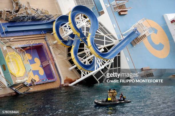 Military rescuers patrol next to the Costa Concordia on January 15, 2012 after the cruise ship ran aground and keeled over off the Isola del Giglio,...