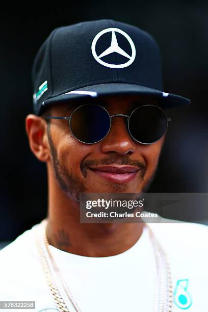 Lewis Hamilton of Great Britain and Mercedes GP talks in the Paddock during previews ahead of the Formula One Grand Prix of Hungary at Hungaroring on...