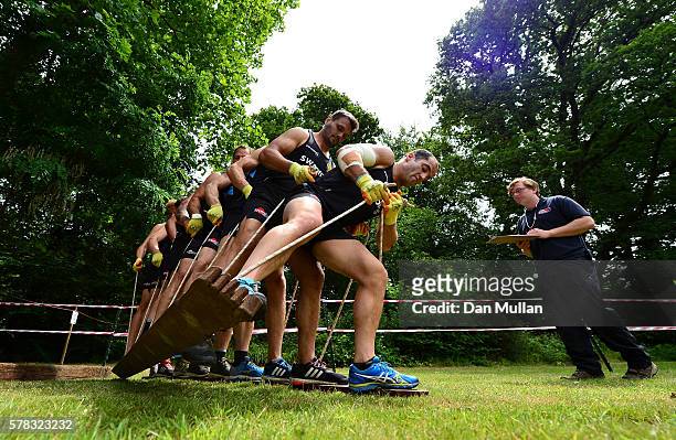 Haydn Thomas of Exeter Chiefs leads his team over an obstacle during a team building exercise at River Dart Country Park on July 21, 2016 in...