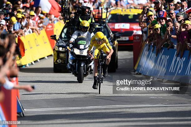Great Britain's Christopher Froome, wearing the overall leader's yellow jersey, rides towards the finish line at the end of the 17 km individual...