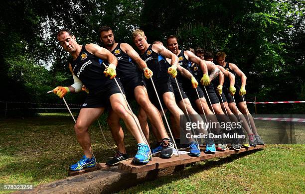 Haydn Thomas of Exeter Chiefs leads his team over an obstacle during a team building exercise at River Dart Country Park on July 21, 2016 in...