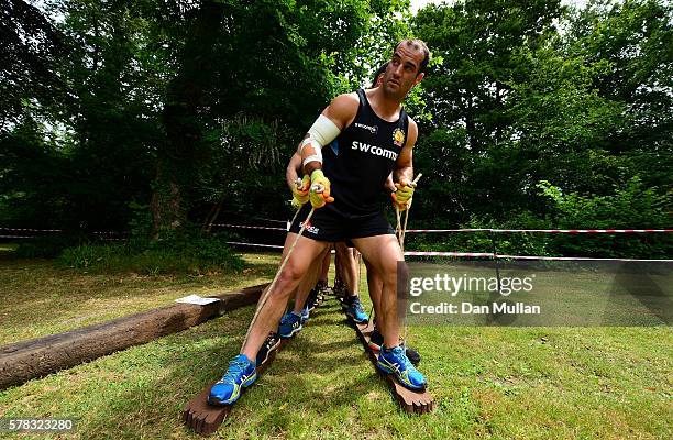 Haydn Thomas of Exeter Chiefs leads his team over an obstacle during a team building exercise at River Dart Country Park on July 21, 2016 in...