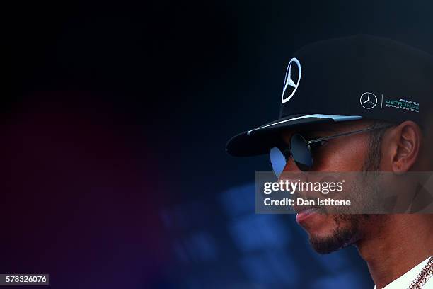 Lewis Hamilton of Great Britain and Mercedes GP speaks with members of the media in the Paddock during previews ahead of the Formula One Grand Prix...