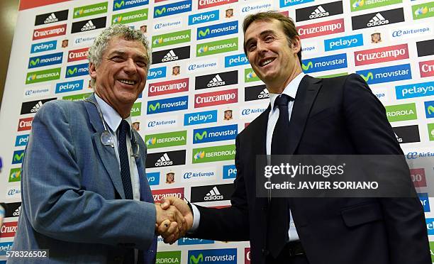 Spanish coach Julen Lopetegui shakes hands with the president of the Spanish football federation Angel Maria Villar after a press conference...