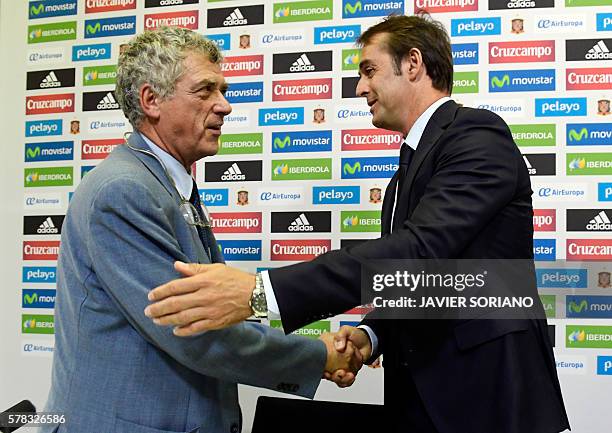 Spanish coach Julen Lopetegui shakes hands with the president of the Spanish football federation Angel Maria Villar after a press conference...