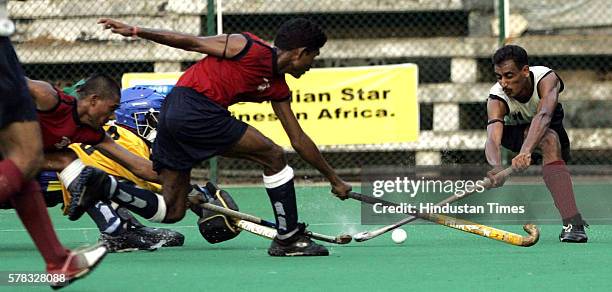 MUMBAI, INDIA OCTOBER 18, 2005: RASHID ALI OF CENTRAL RAILWAY TRYING TO PUT THE BALL IN THE NET AS AKIL SHAIKH , VINOD SELOKAR AND WAHID PATHAN OF MS...