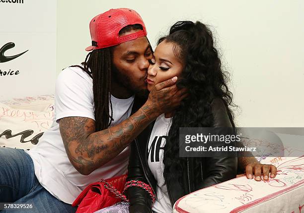 Rapper Waka Flocka and TV personality Tammy Rivera share a kiss at Music Choice on July 21, 2016 in New York City.