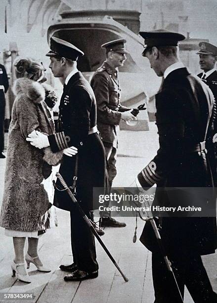 Photograph of Edward, Prince of Wales , kissing his sister-in-law goodbye, before leaving to visit Australasia. Also pictured is Prince Albert...