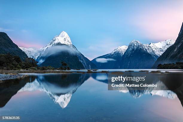 awesome sunrise at milford sound, new zealand - snowcapped mountain stock pictures, royalty-free photos & images