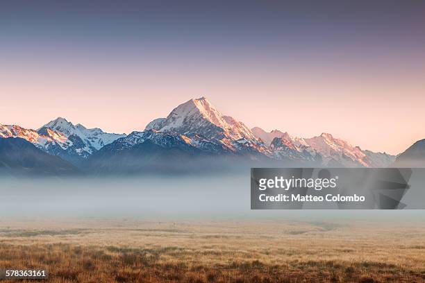 mt cook emerging from mist at dawn, new zealand - new zealand stock pictures, royalty-free photos & images