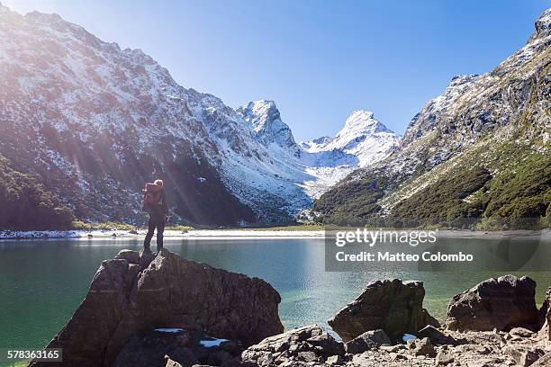 hiker standind at lake mackenzie, routeburn track - fiordland national park stock pictures, royalty-free photos & images