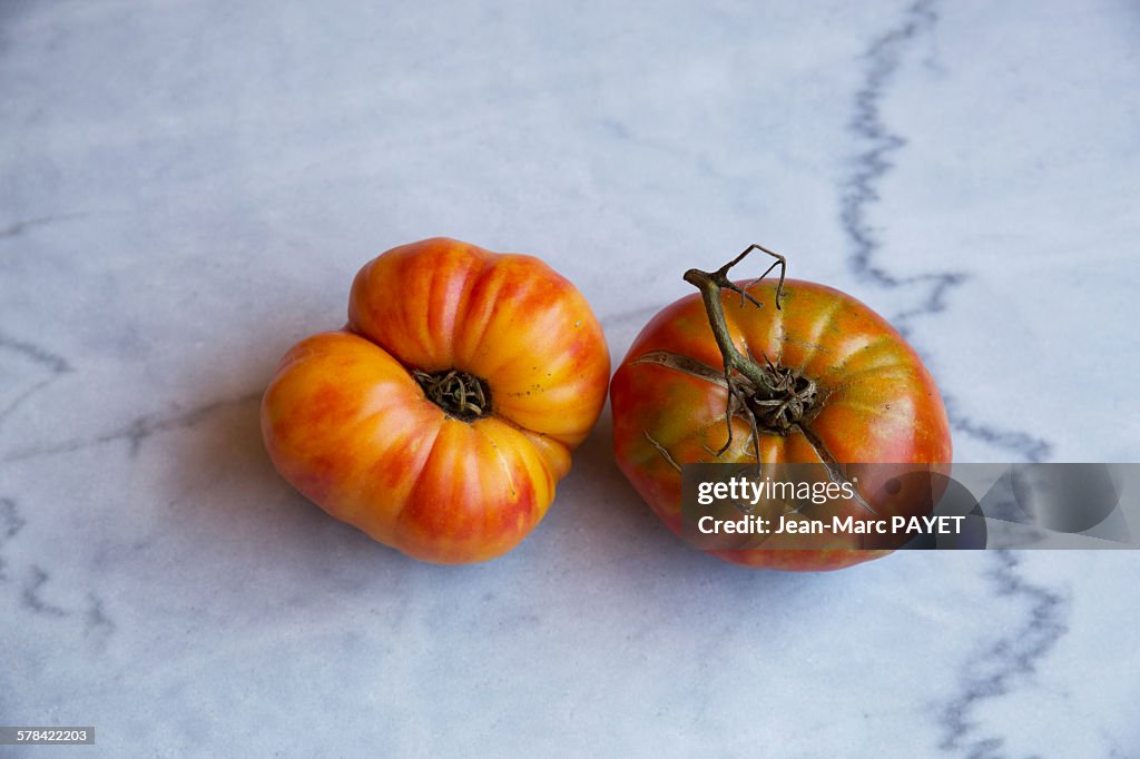 True organic tomatoes "beef heart" on a marble tab